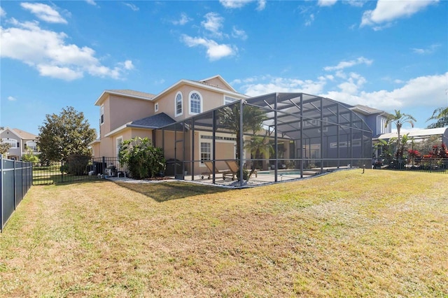 back of house with a yard, a lanai, a fenced in pool, and a patio area