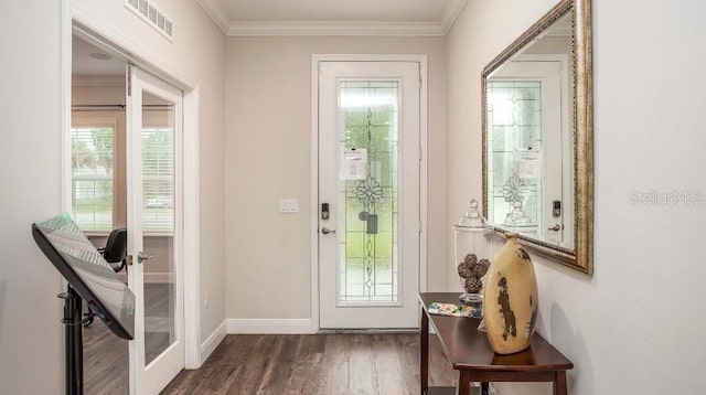 entryway featuring dark wood-type flooring, ornamental molding, and french doors