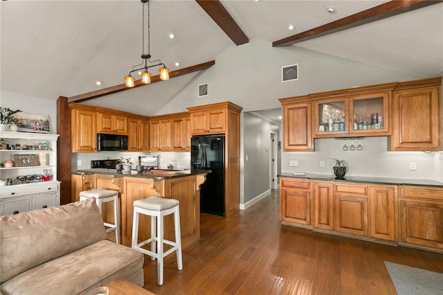 kitchen featuring a kitchen bar, hanging light fixtures, dark hardwood / wood-style flooring, beam ceiling, and black appliances