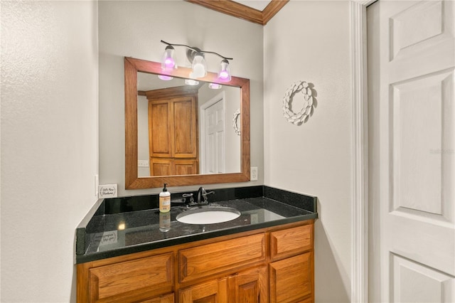 bathroom featuring ornamental molding and vanity