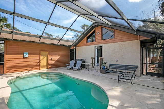 rear view of property featuring a lanai and a patio area