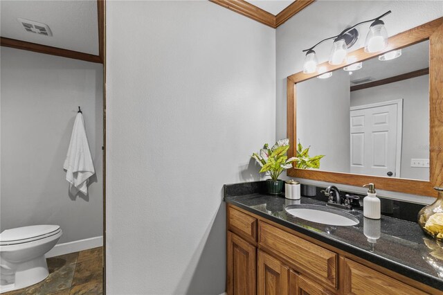 2929 Lakeshore Dr, Mount Dora, FL 32757 - bathroom featuring vanity, toilet, ornamental molding, and stone finish floors