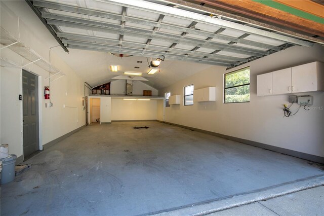 2929 Lakeshore Dr, Mount Dora, FL 32757 - garage featuring a garage door opener and baseboards