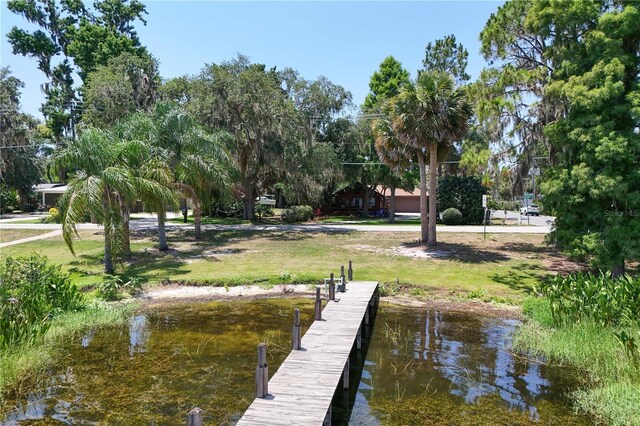2929 Lakeshore Dr, Mount Dora, FL 32757 - dock featuring a lawn and a water view
