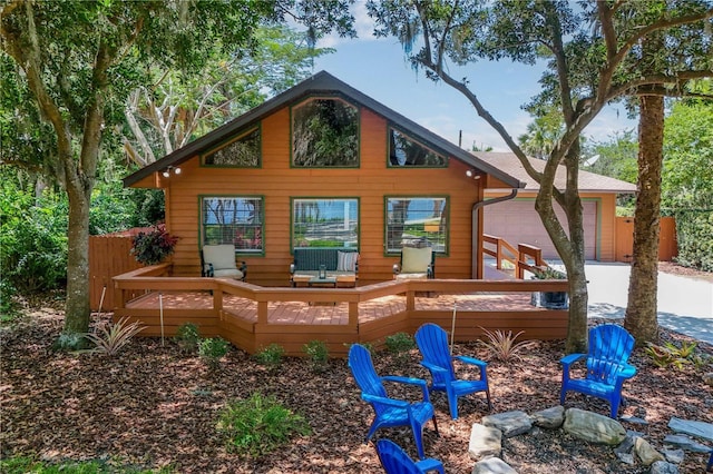 2929 Lakeshore Dr, Mount Dora, FL 32757 - back of property featuring an attached garage, a wooden deck, and concrete driveway