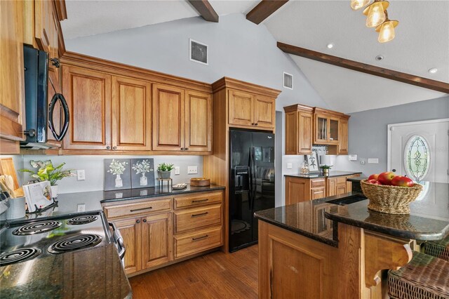 2929 Lakeshore Dr, Mount Dora, FL 32757 - kitchen featuring black appliances, beamed ceiling, brown cabinets, dark wood-style floors, and a kitchen breakfast bar