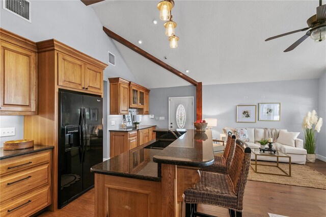 2929 Lakeshore Dr, Mount Dora, FL 32757 - kitchen with black fridge, a sink, open floor plan, ceiling fan, and brown cabinetry