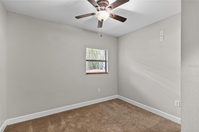 2929 Lakeshore Dr, Mount Dora, FL 32757 - spare room featuring carpet floors, baseboards, and a ceiling fan