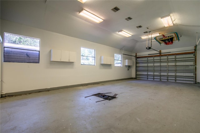 2929 Lakeshore Dr, Mount Dora, FL 32757 - garage featuring a garage door opener and baseboards