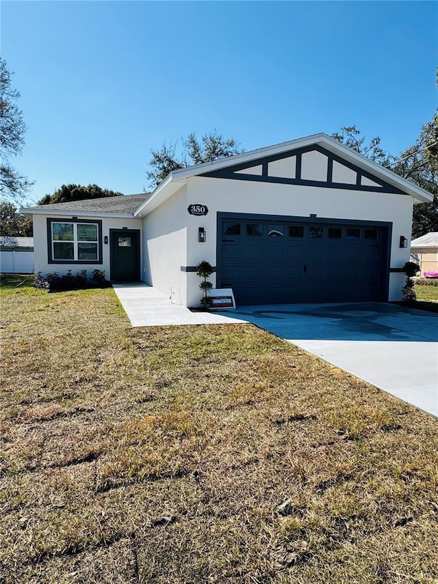 ranch-style home with a garage and a front yard