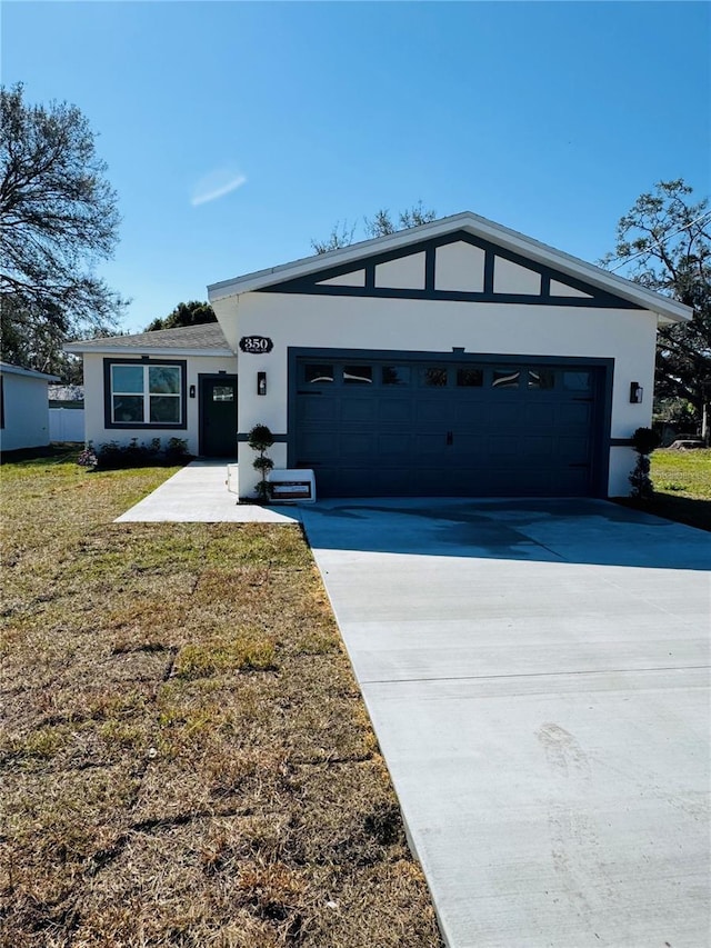 view of front of home with a garage and a front yard