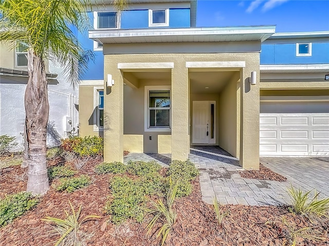 doorway to property featuring stucco siding