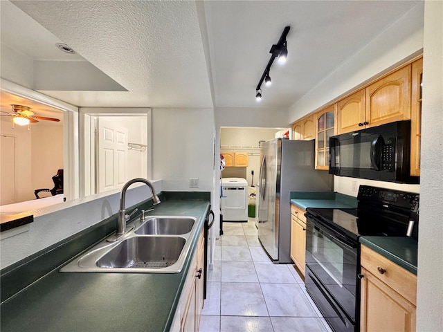 kitchen featuring sink, ceiling fan, black appliances, a textured ceiling, and washer / dryer