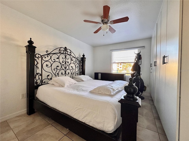 tiled bedroom featuring ceiling fan