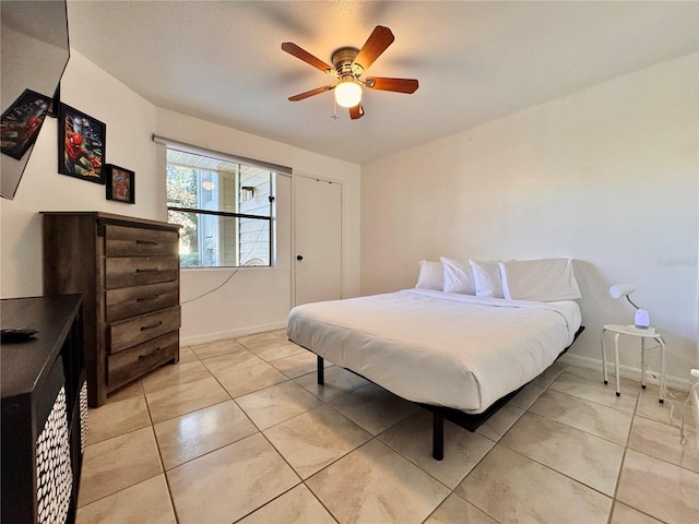 bedroom featuring ceiling fan and light tile patterned floors