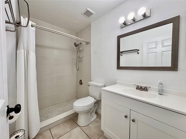 bathroom with tile patterned flooring, vanity, a shower with curtain, and toilet