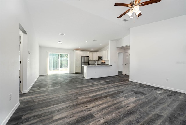 unfurnished living room featuring ceiling fan, lofted ceiling, dark hardwood / wood-style floors, and sink