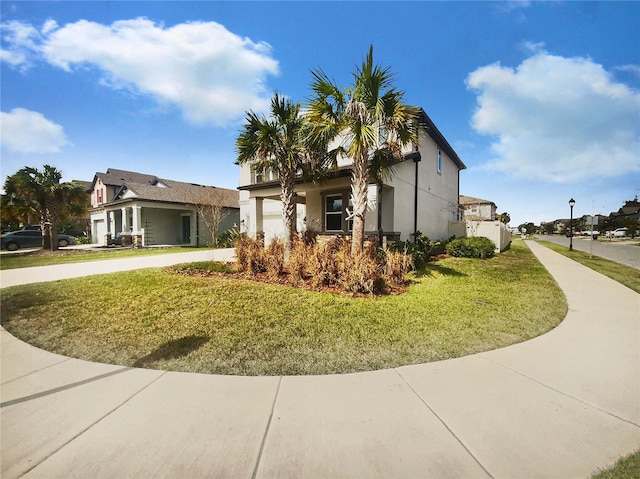 view of front of house featuring a garage and a front lawn