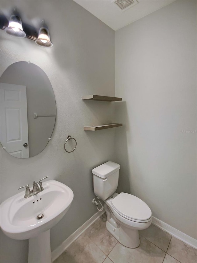 bathroom featuring tile patterned floors, toilet, and sink