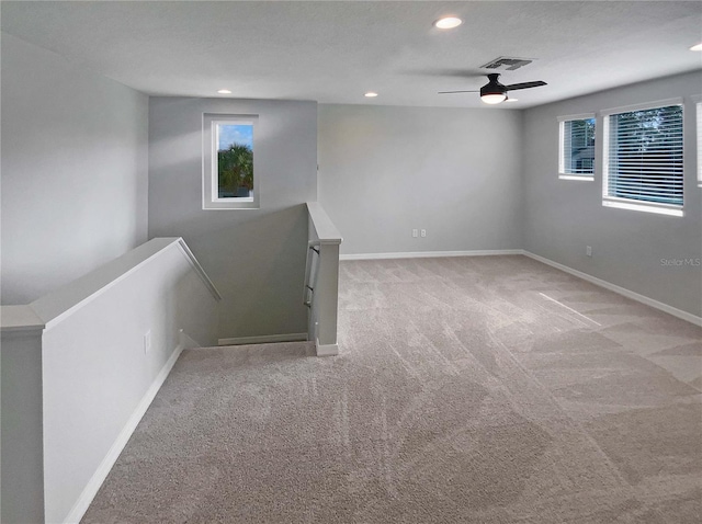 carpeted empty room with ceiling fan