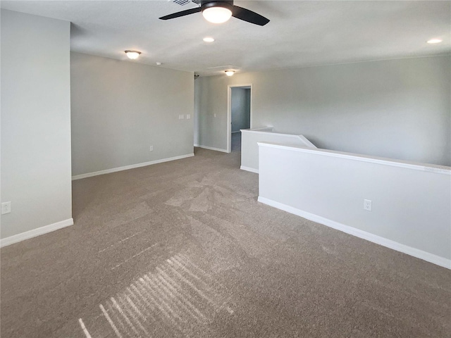 spare room with carpet floors and ceiling fan