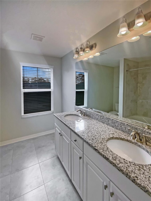 full bathroom featuring tile patterned flooring, vanity, shower / bathtub combination, and toilet