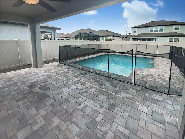 view of swimming pool with ceiling fan and a patio area