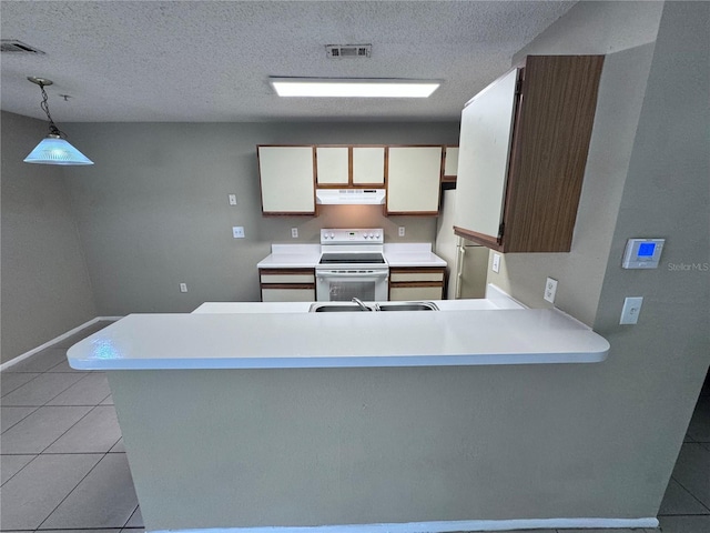 kitchen featuring pendant lighting, white cabinets, light tile patterned floors, kitchen peninsula, and white appliances