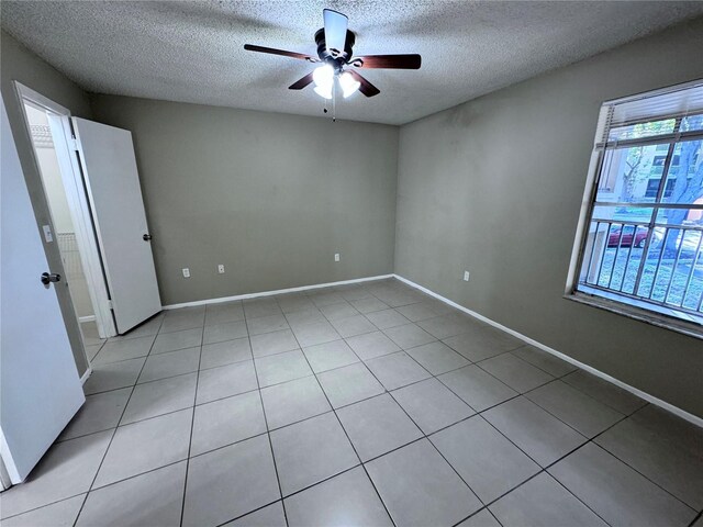 empty room featuring a textured ceiling and ceiling fan