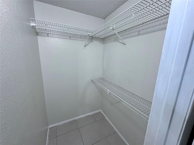 spacious closet featuring tile patterned flooring