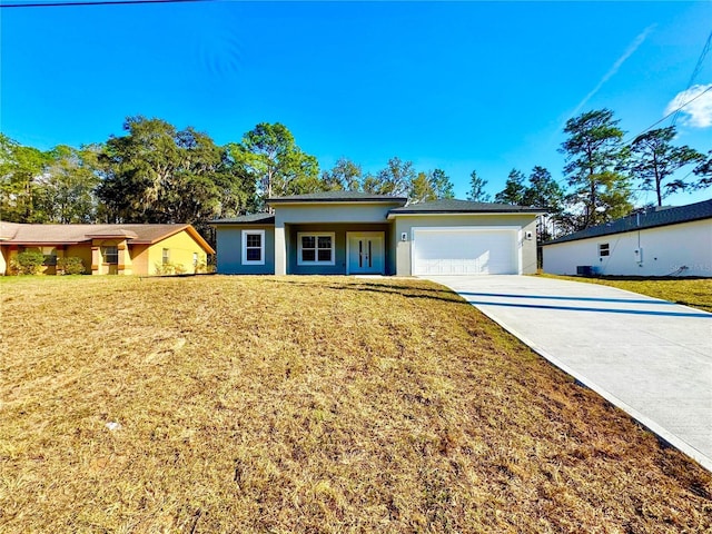 view of front of home with a garage and a front yard