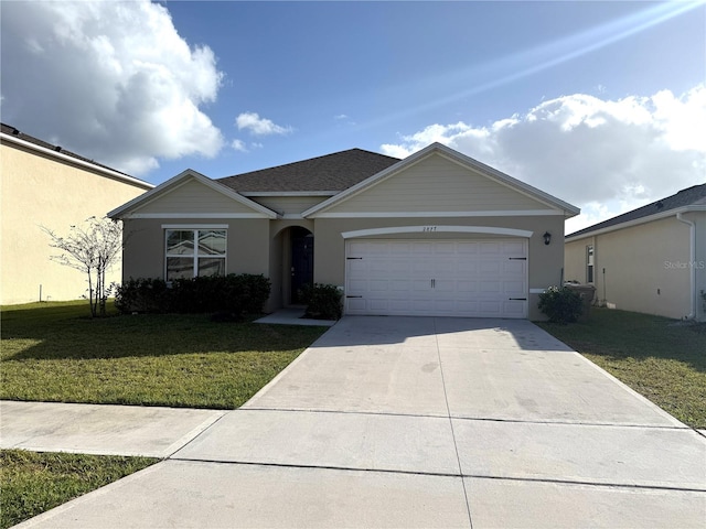 ranch-style house featuring a garage and a front lawn