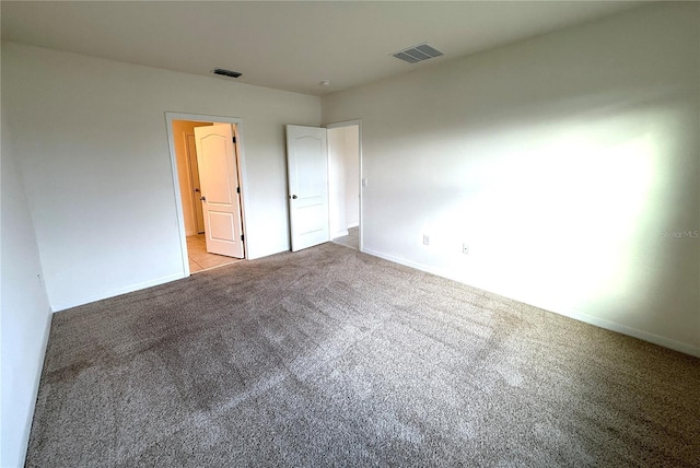 unfurnished bedroom with light colored carpet