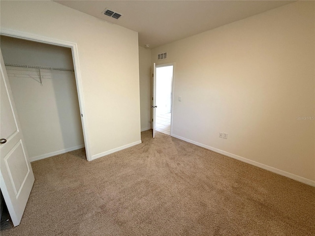 unfurnished bedroom featuring a closet and carpet