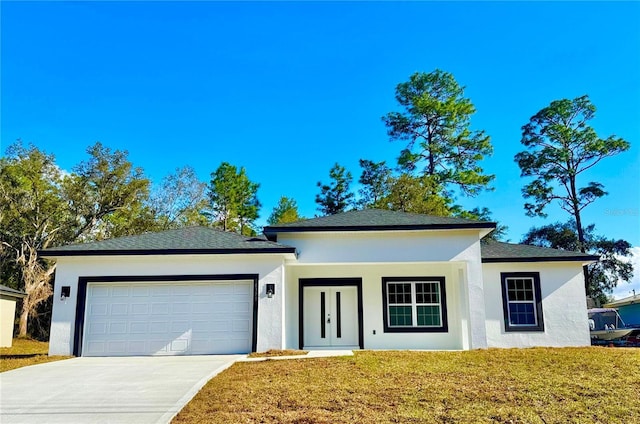 view of front of house featuring a garage and a front lawn