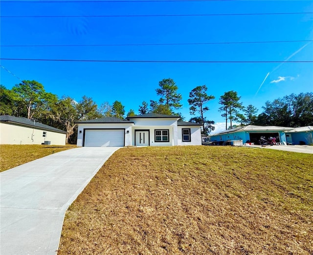 view of front facade featuring a garage and a front lawn