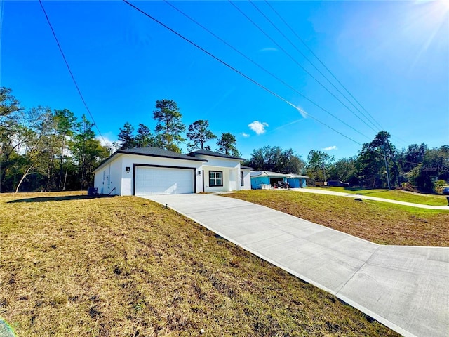 view of front of home featuring a garage and a front lawn