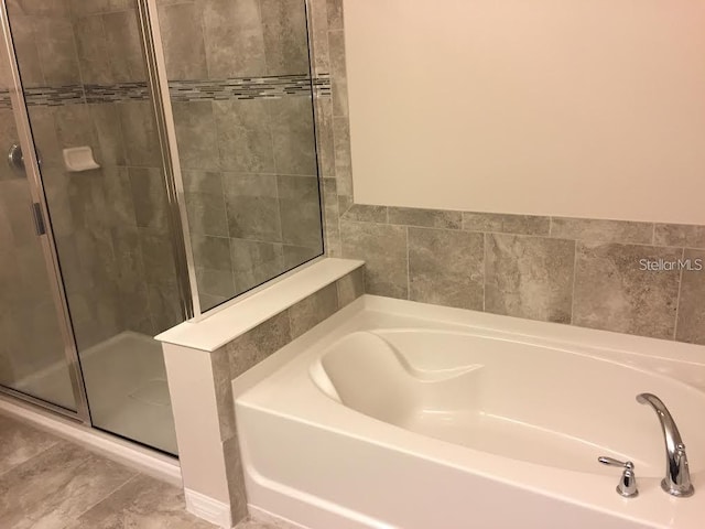 bathroom featuring separate shower and tub