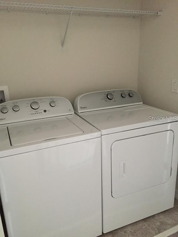 clothes washing area with washing machine and clothes dryer