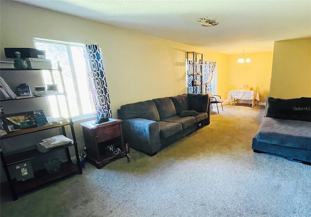 carpeted living room with a notable chandelier