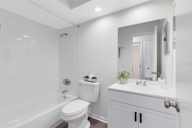 full bathroom featuring tiled shower / bath, wood-type flooring, vanity, and toilet