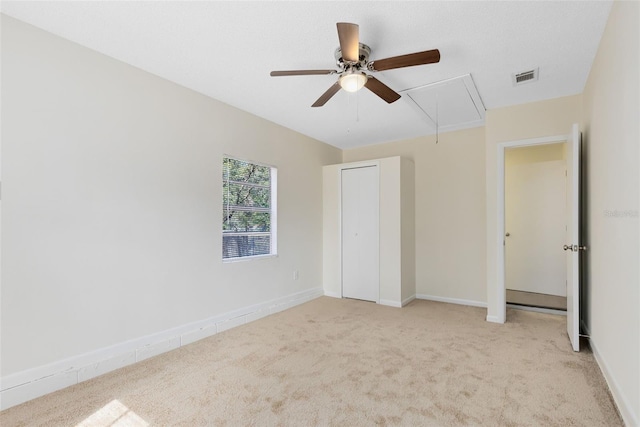 unfurnished bedroom featuring ceiling fan and light colored carpet