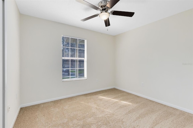 unfurnished room with ceiling fan and light colored carpet