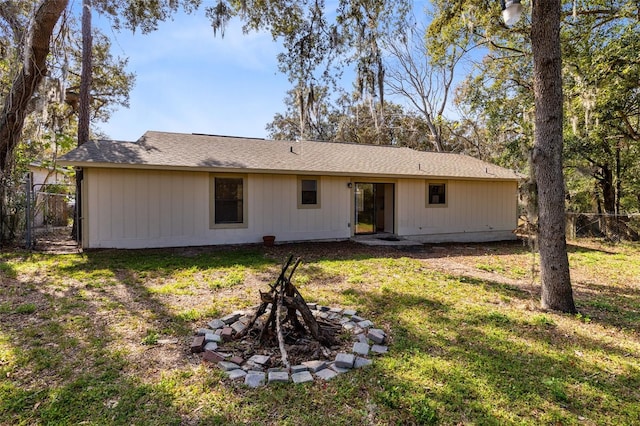 back of house with a lawn