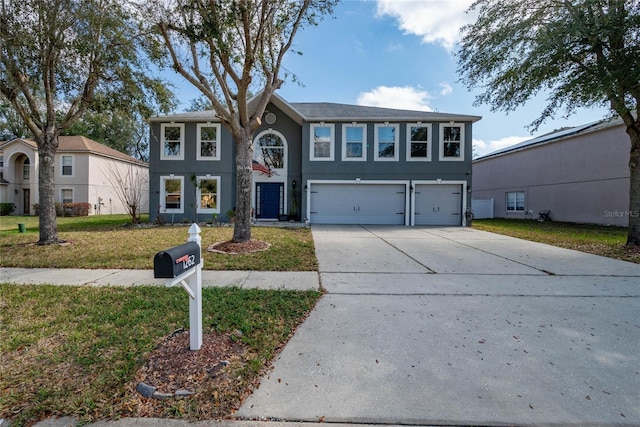 view of front of home with an attached garage, driveway, a front lawn, and stucco siding