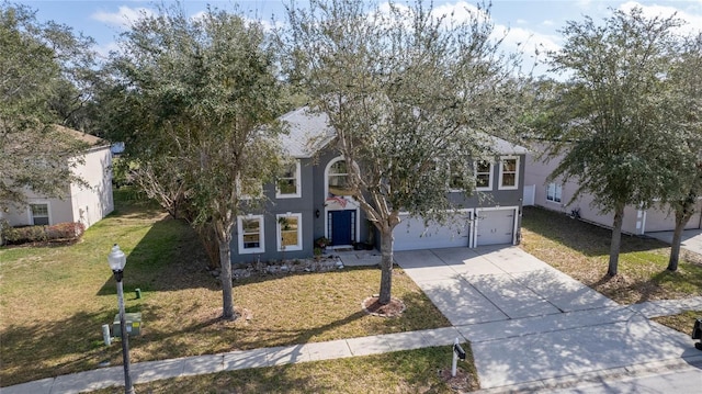 obstructed view of property with driveway, a garage, a front lawn, and stucco siding