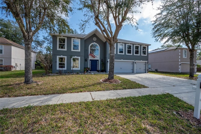 view of front of house with a front lawn, driveway, an attached garage, and stucco siding