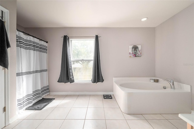 bathroom featuring a garden tub, recessed lighting, baseboards, and tile patterned floors