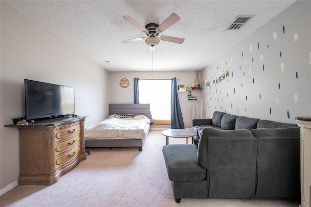 bedroom featuring a textured ceiling, ceiling fan, light colored carpet, visible vents, and baseboards