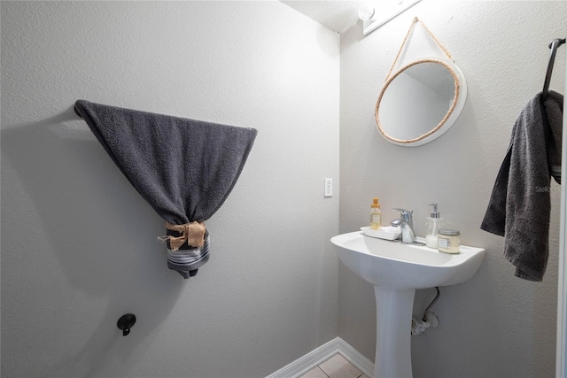 bathroom featuring tile patterned flooring and baseboards